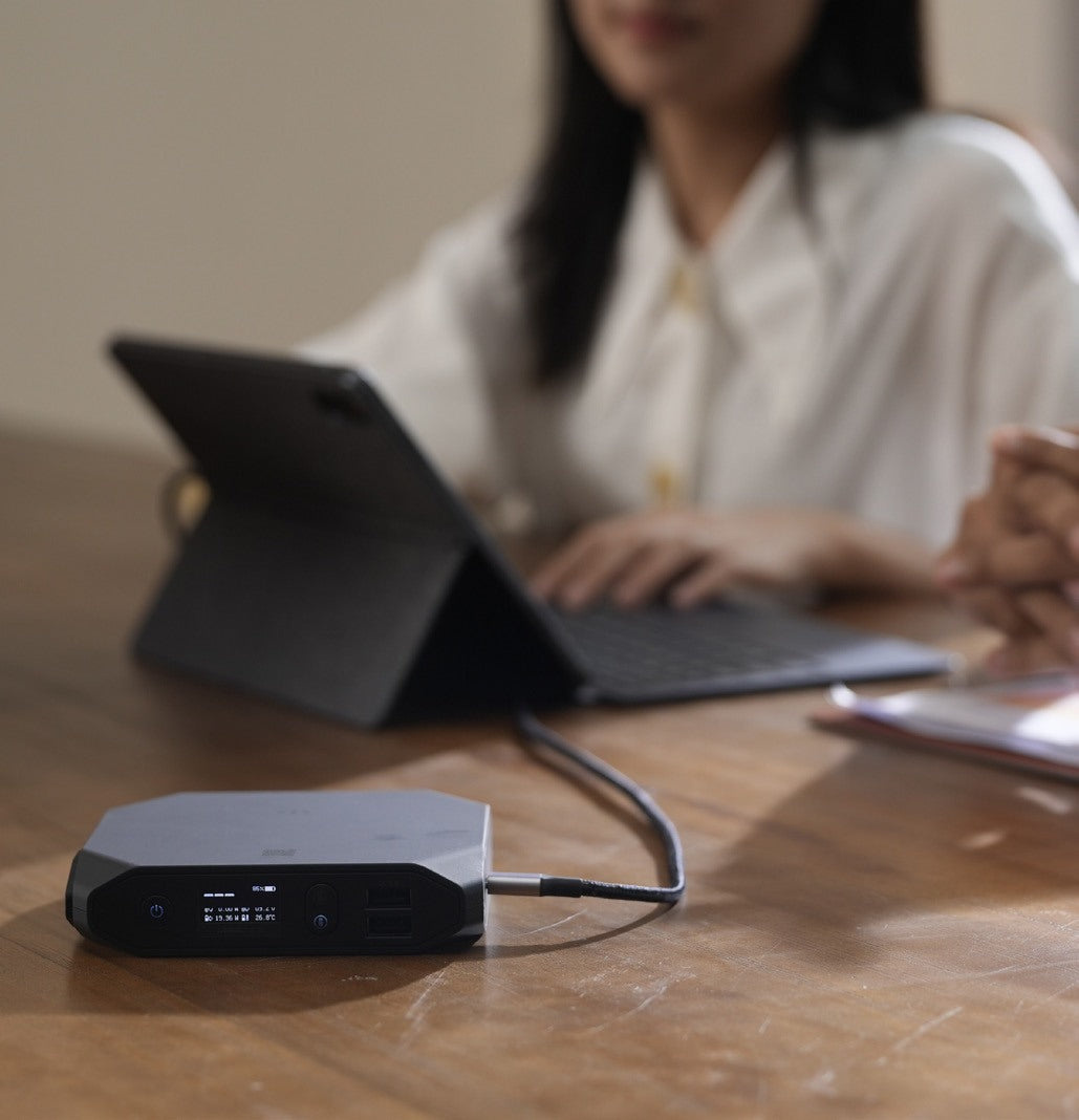 Patron using a tablet connected to an Omnicharge power bank