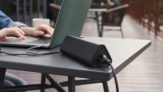 Omni 40+ on a patio table next to a laptop